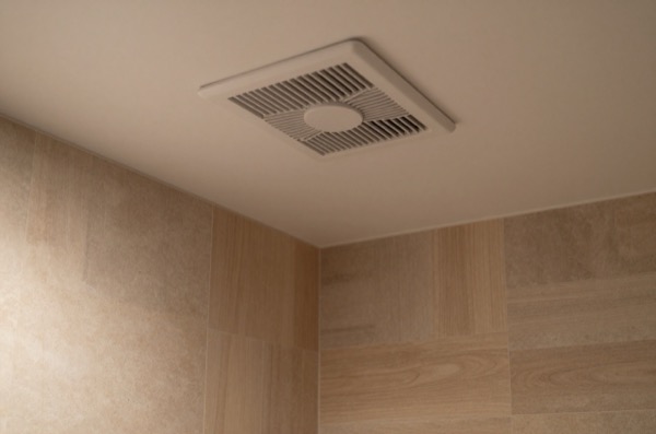 Linear grille fan in minimalist en-suite bathroom.
