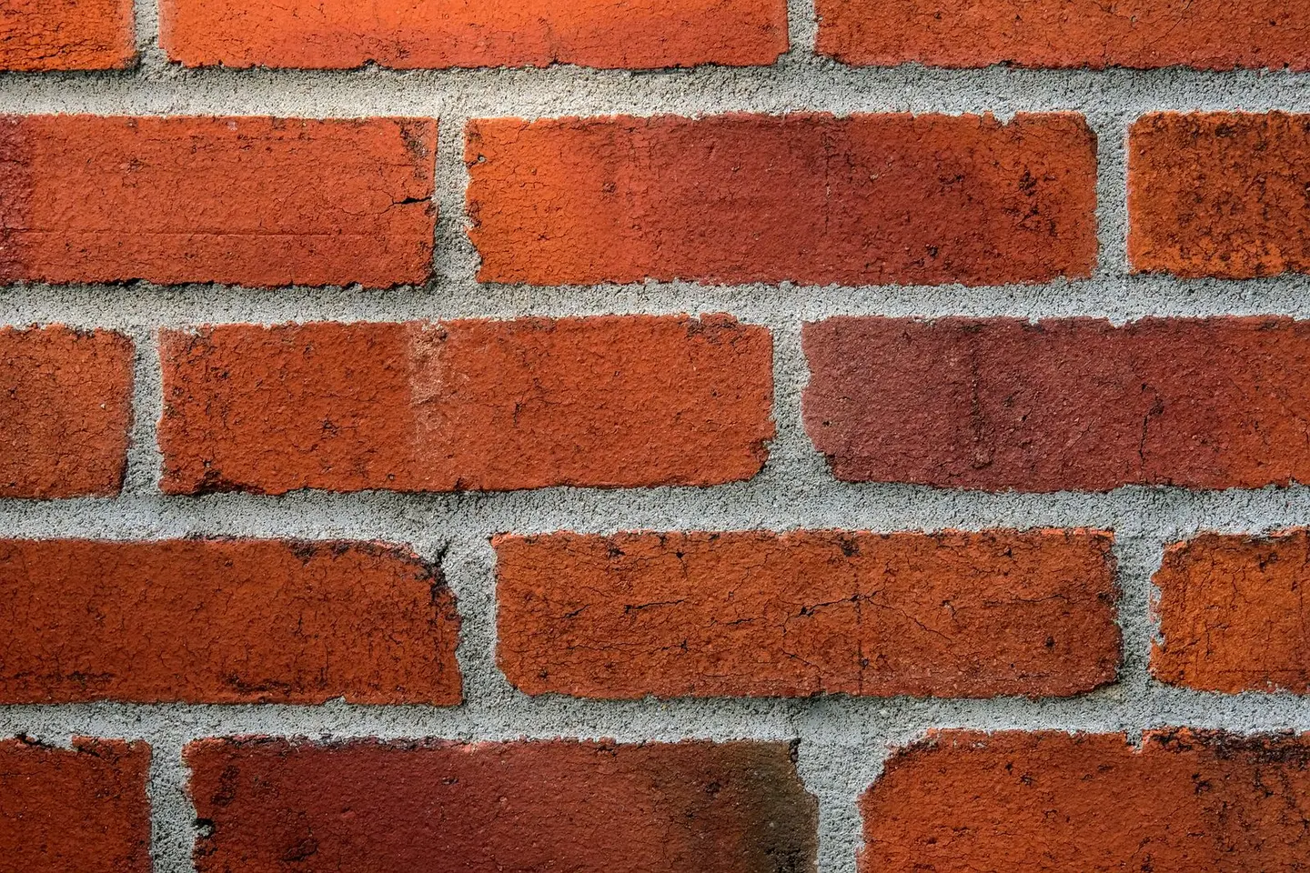 Detailed close-up of a red brick wall showing texture and mortar lines.